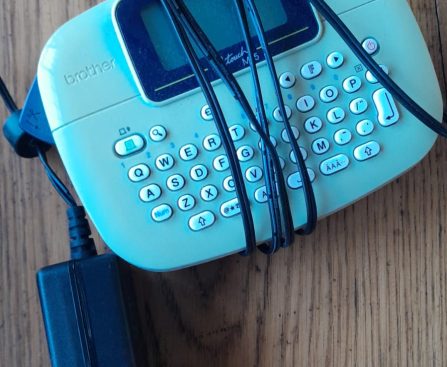 The Brother P-Touch PT-M95 is a compact, handheld label maker designed for quick and easy organization at home, school, or the office. It features a QWERTY keyboard and prints up to two lines of text on 9mm or 12mm non-laminated M-series tapes.
