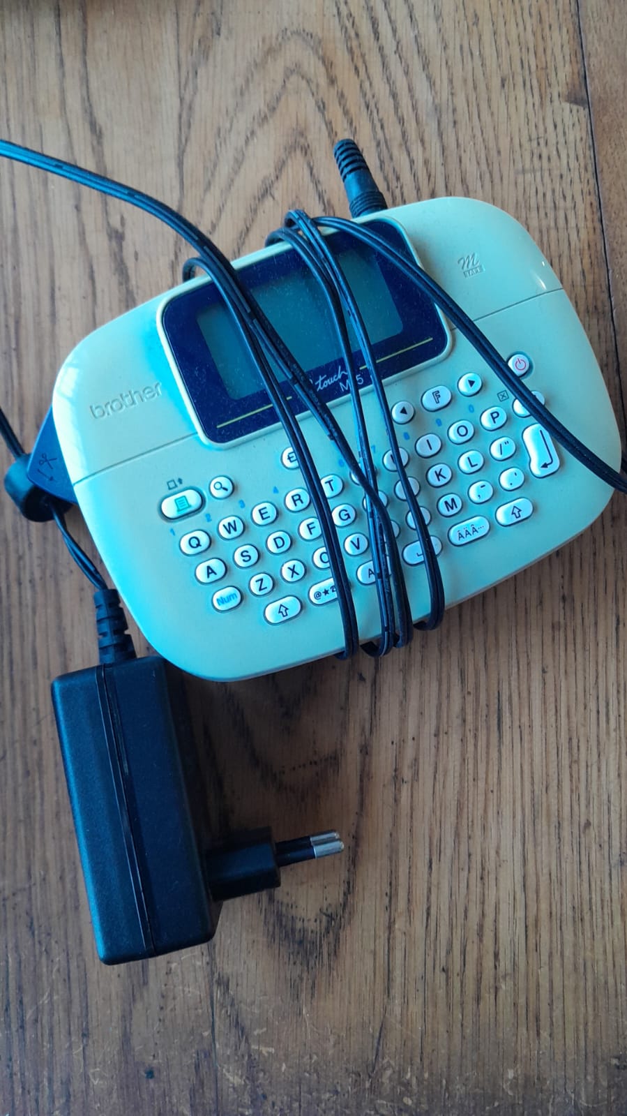 The Brother P-Touch PT-M95 is a compact, handheld label maker designed for quick and easy organization at home, school, or the office. It features a QWERTY keyboard and prints up to two lines of text on 9mm or 12mm non-laminated M-series tapes.